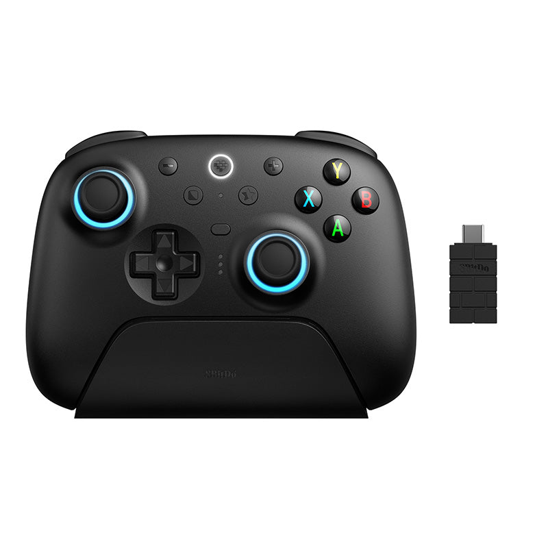 8BitDo Ultimate 2 Wireless Controller in black sitting on its charging dock, with the USB-C 2.4G adapter beside it
