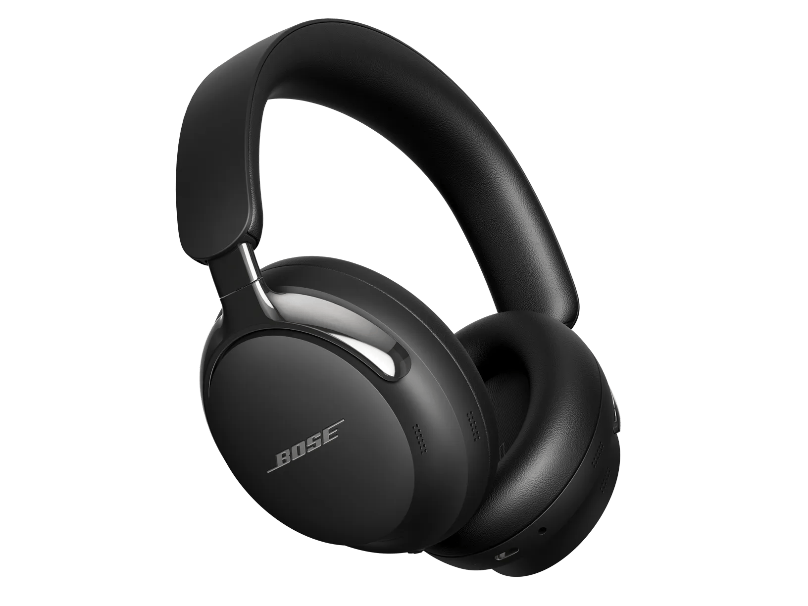 Black Bose QuietComfort Ultra Headphones (2nd Gen) in a three-quarter view, the leather-wrapped headband arched upward, a polished metal yoke above the near ear cup, silver BOSE lettering on the outer face of the near cup, and the far cup's cushion turned toward the viewer