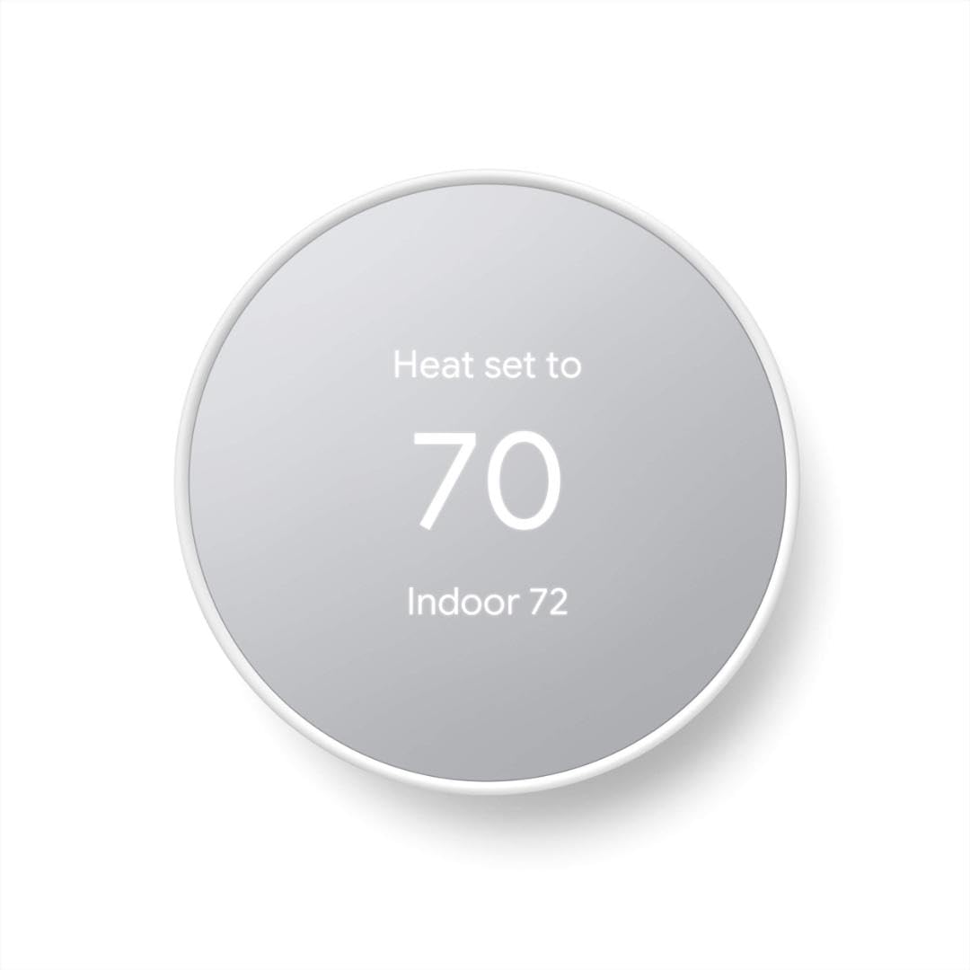 Google Nest Thermostat in Snow seen face-on: a round unit with a white rim and a mirrored gray display reading Heat set to 70 and Indoor 72, on a plain off-white background