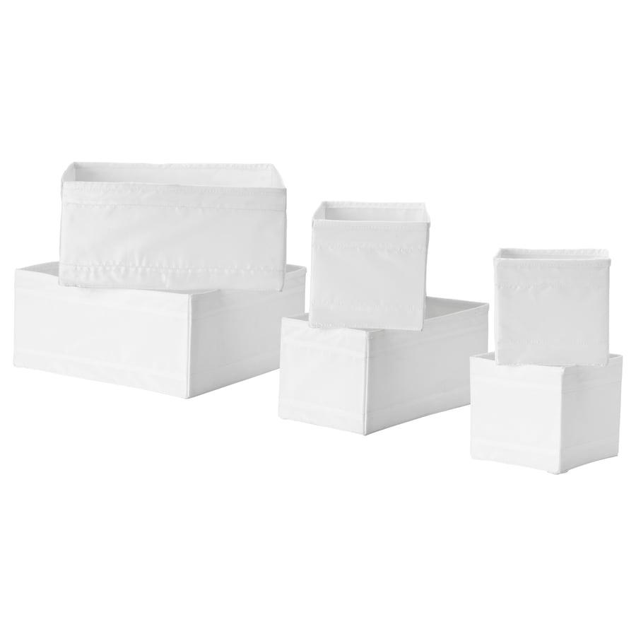 Six white IKEA SKUBB fabric boxes in three sizes, arranged as a set