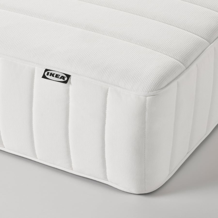 IKEA VALEVÅG medium firm pocket spring mattress in white, shown flat with the quilted top and side panel visible