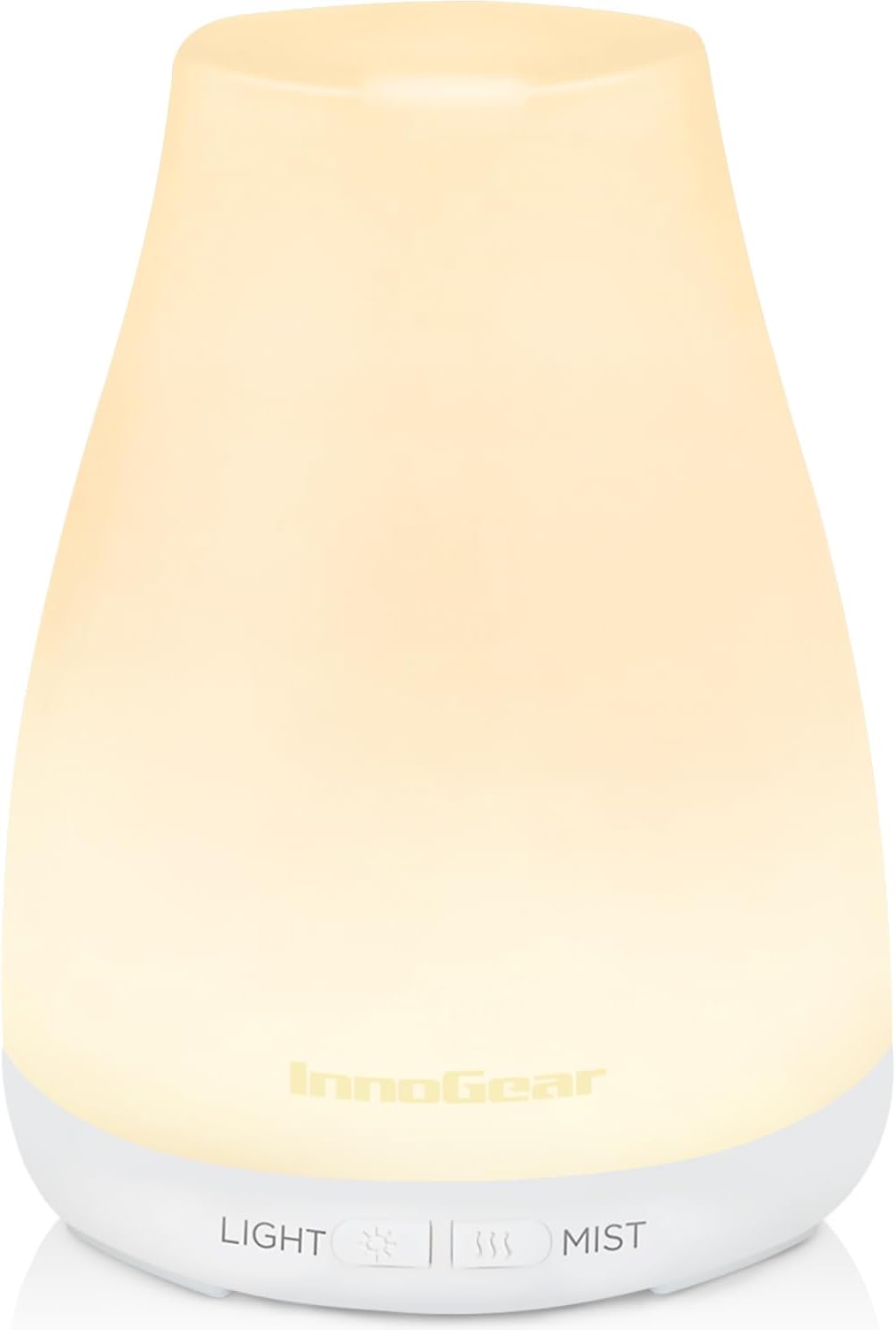InnoGear 100ml diffuser in Basic White with its LED glowing warm amber, InnoGear wordmark on the shade, white base showing the LIGHT and MIST buttons, on a white background