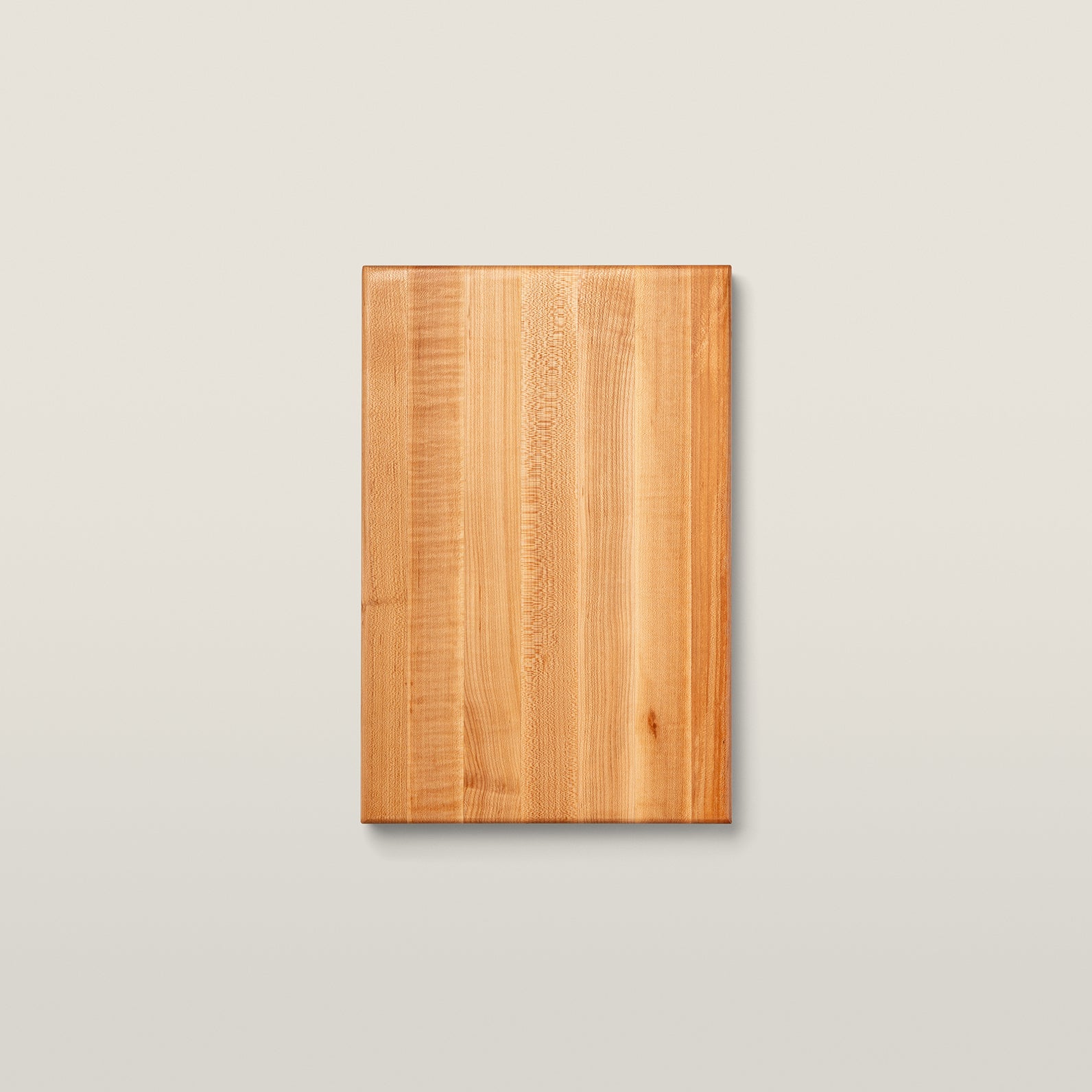 John Boos R01 maple edge-grain cutting board seen from above — a plain 18-by-12 slab of pale maple with visible grain, on a neutral studio background