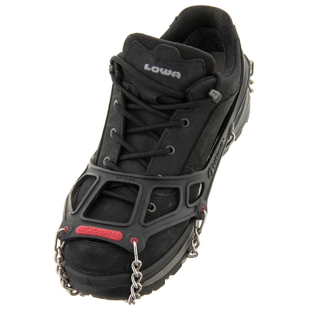 Kahtoola MICROspikes with a black harness stretched over a black hiking shoe, viewed from the front