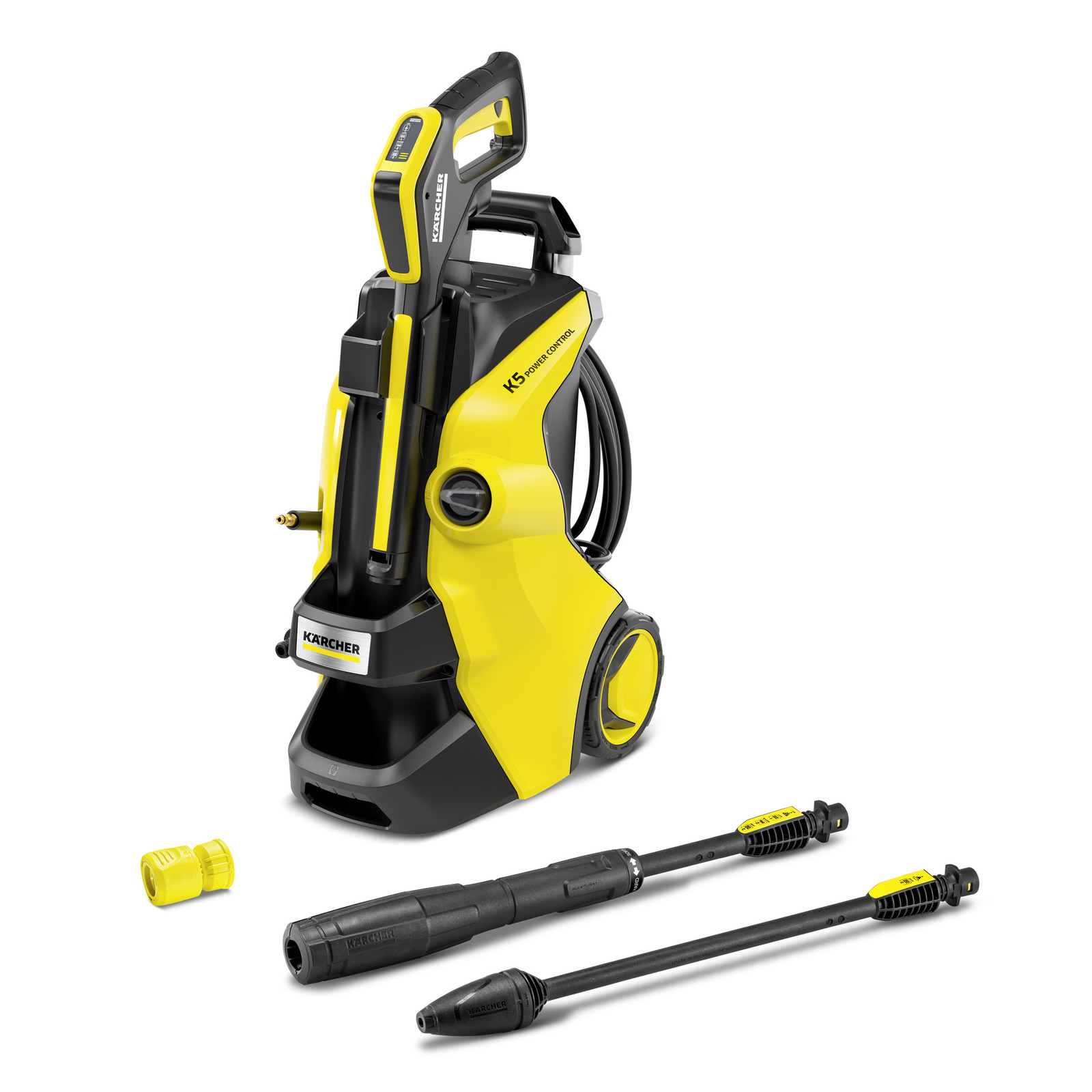 Yellow and black Kärcher K 5 Power Control pressure washer on a plain white background, seen at a three-quarter angle from the front, with the KÄRCHER badge low on the black front face, K5 POWER CONTROL printed in black on the yellow side panel that runs back to one black-and-yellow wheel, the yellow-and-black Power Control spray gun standing in its front holder with a segmented pressure display at its top, a coil of black high-pressure hose hung along the right side, and two black spray lances plus a small yellow quick-connect fitting lying on the ground in front