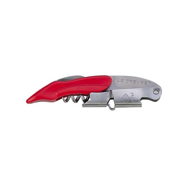 Le Creuset Waiter's Friend corkscrew closed, with a Cerise red handle and a folded two-step steel foot, on white