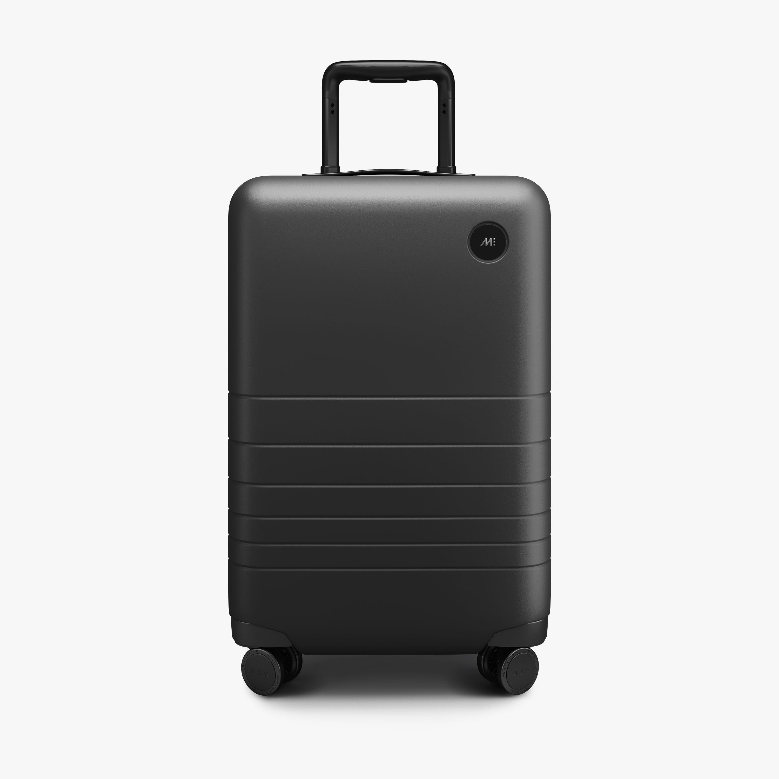 Midnight Black Monos Carry-On hardside suitcase, front view with handle collapsed
