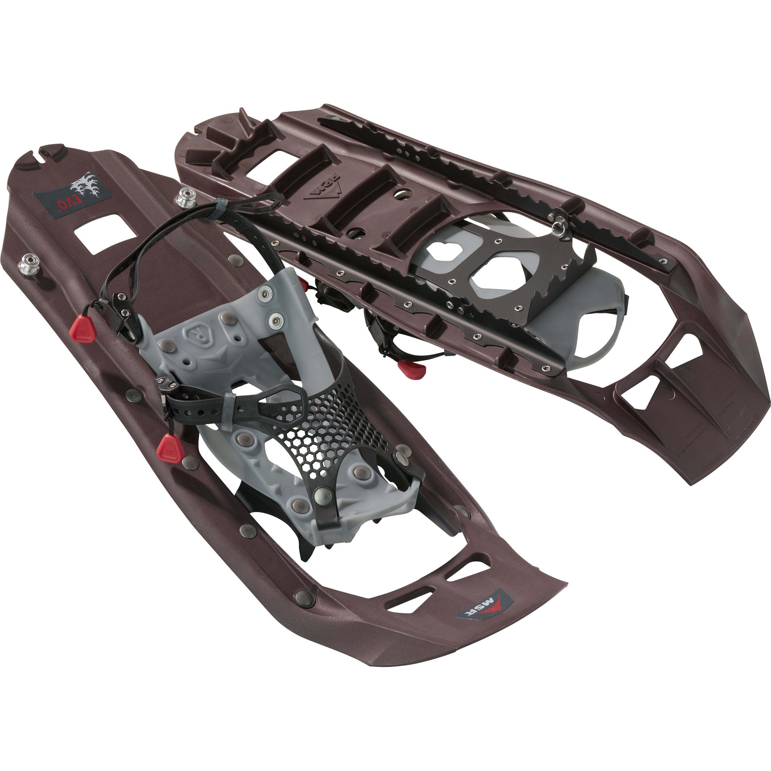 Pair of MSR Evo Trail snowshoes stacked at an angle on a white background, showing the dark maroon-brown molded decks of the Iron colorway, black traction rails, and gray bindings with black mesh straps and red pull tabs