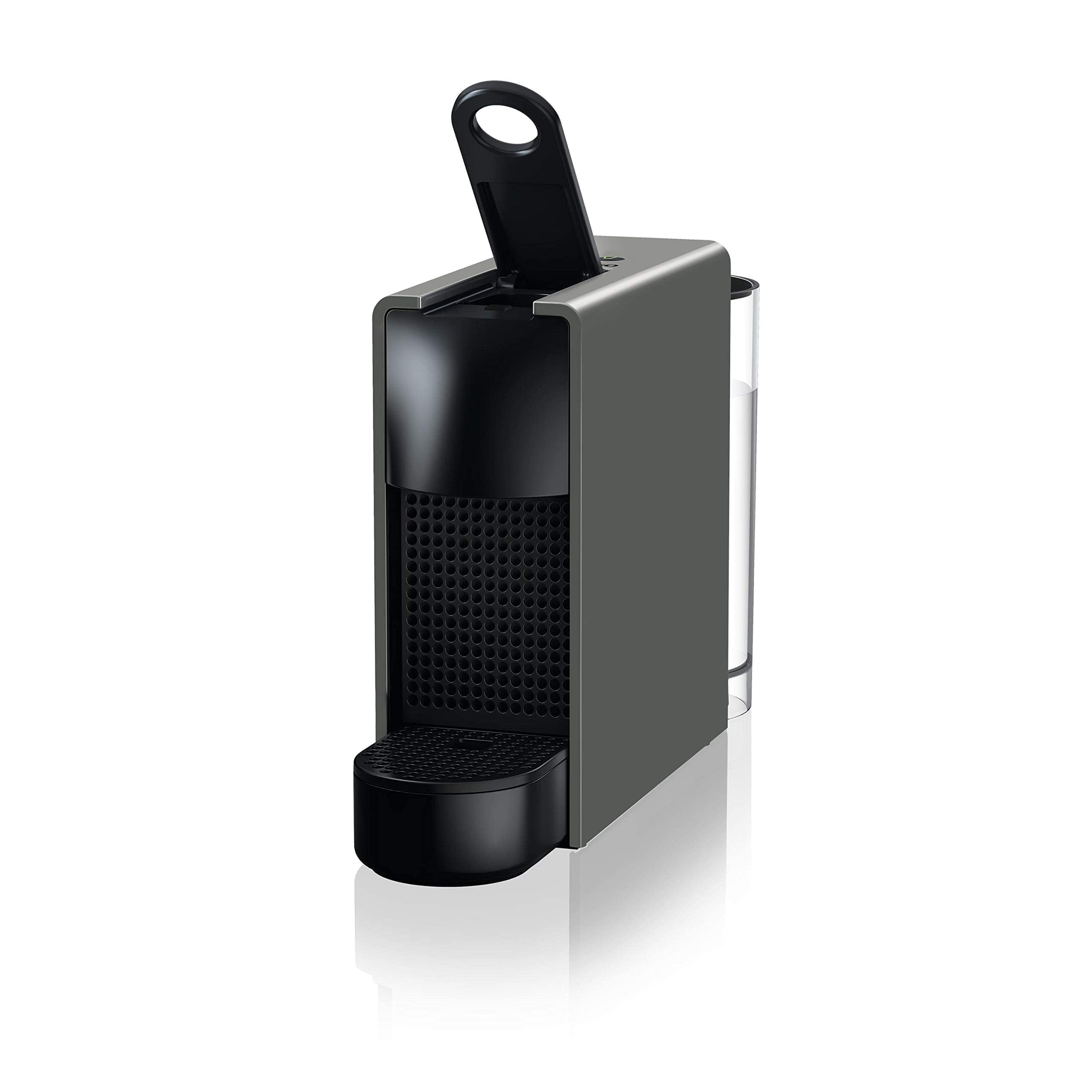 Nespresso Essenza Mini C30 in Intense Grey, seen from the front left with the lever raised, its clear water tank sitting at the rear and the black drip tray below, on a plain white background