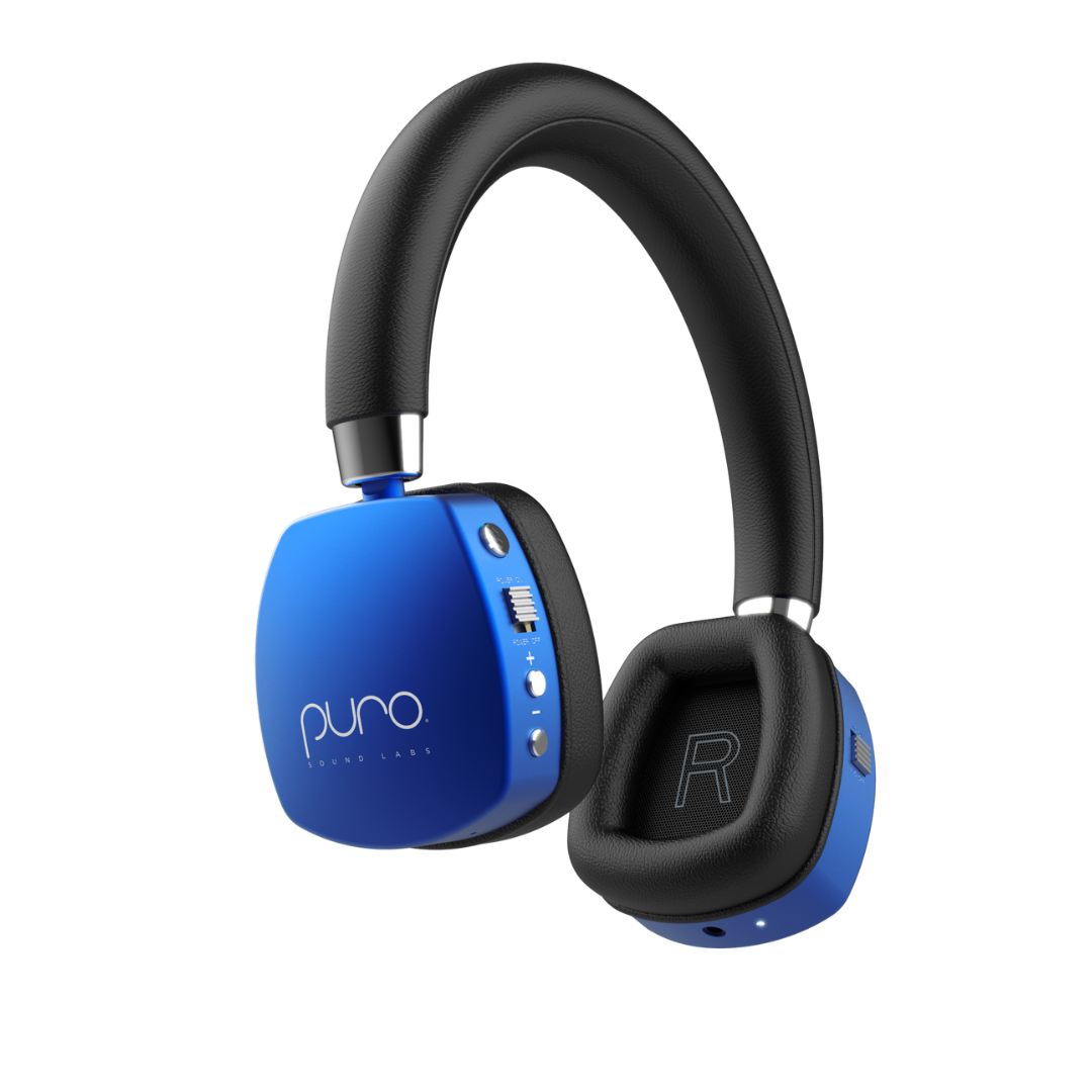 PuroQuiet Plus kids headphones in blue with a black headband and black earcups, one earcup turned to show the Puro logo and controls, on a plain white background