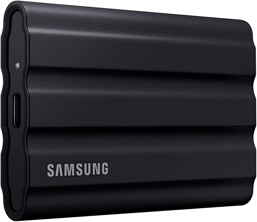 Black Samsung Portable SSD T7 Shield with ribbed rubber shell and USB-C port, angled front view