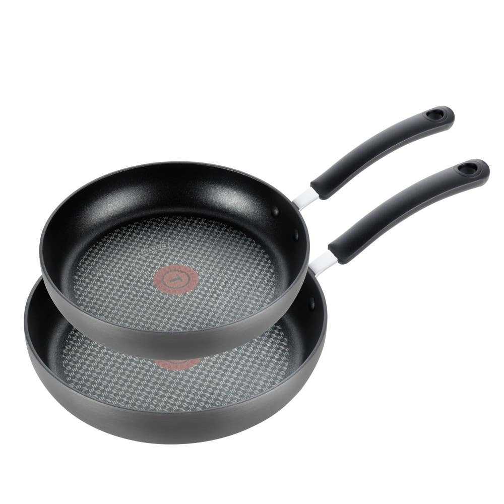 Two T-fal Ultimate hard anodized fry pans with gray exteriors, textured black nonstick interiors and red Thermo-Spot centers, nested with black handles angled right on a white background
