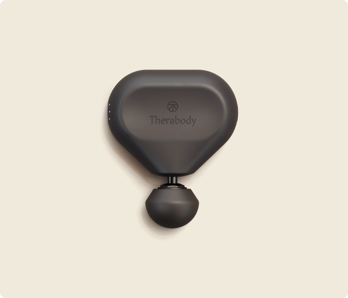 Theragun Mini 3rd Gen massage gun in black with its standard attachment