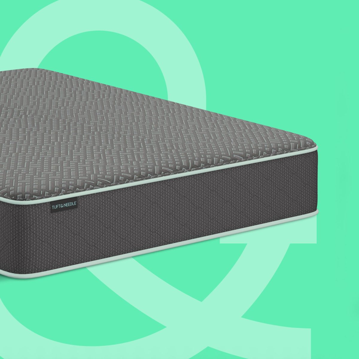 Tuft & Needle Original Mattress II shown at an angle, dark gray knit top with a white edge trim and a side label