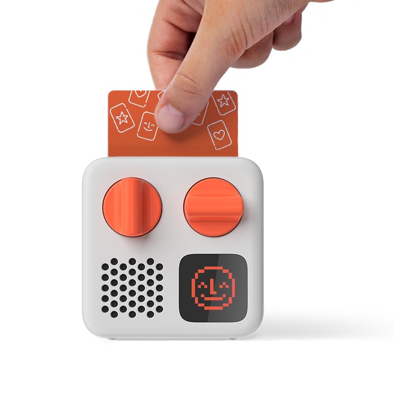 Yoto Mini 2024 Edition kids' audio player, front view, showing the pixel display and two orange knobs